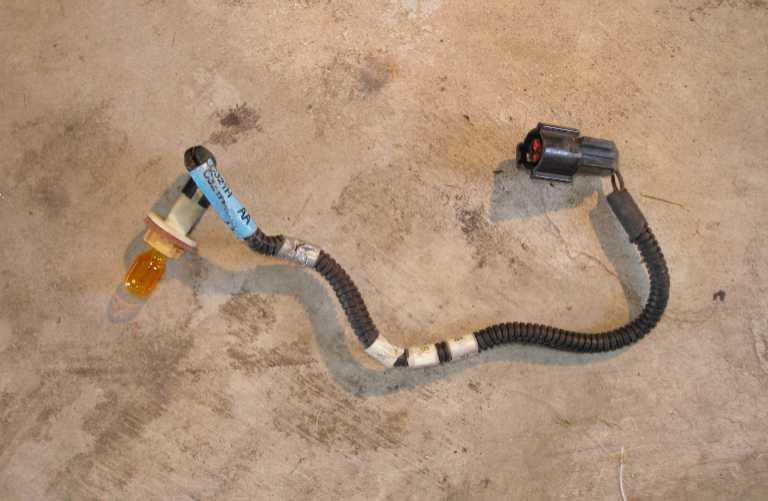 The passenger side corner lamp harness, consisting of a brown wire and a black ground wire. It is the ground wire that needs to be cut and spliced into the turn signal wire.