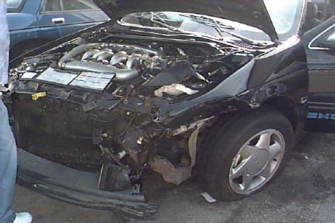 1993 Ford Taurus - Front-end damage visible on a 1993 Ford Taurus, showing the engine compartment.