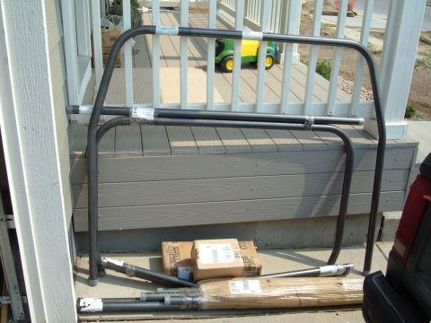 1993 Ford Bronco - Roll cage components are laid out on a deck, ready for installation.