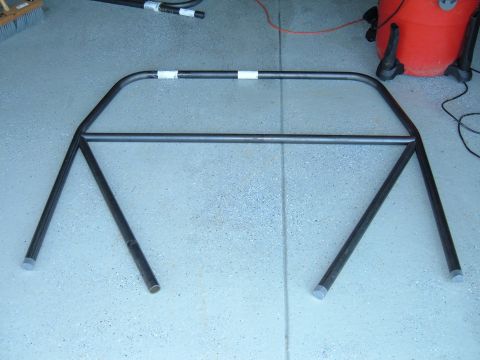 1993 Ford Bronco - Roll cage assembly shown on a garage floor with a shop vac in the background.