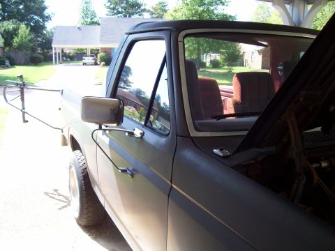1985 Ford Bronco - This 1980s Ford Bronco shows a distinct body style from that era, with its hood up revealing the engine compartment.