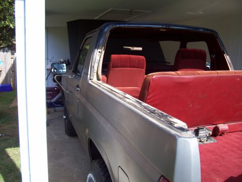 1985 Ford Bronco - Interior view of a Ford Bronco, likely from the 1980s, with red upholstery.