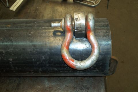 1983 Ford Bronco - A close-up view shows a shackle secured to a heavy-duty metal tube, possibly for off-road vehicle accessories.