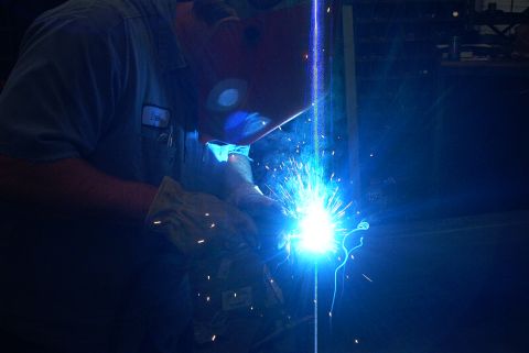 1983 Ford Bronco - A person is welding, creating a bright light and sparks.