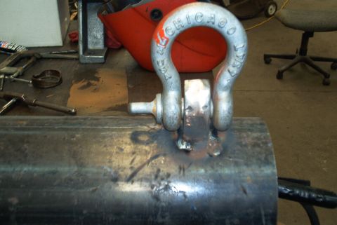 1983 Ford Bronco - A shackle marked 'CHICAGO USA 1987' is welded to a metal tube, likely part of a custom bumper or brush guard.
