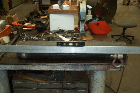 1983 Ford Bronco - A metal pipe is shown with a level placed on top, suggesting a measurement or construction context.