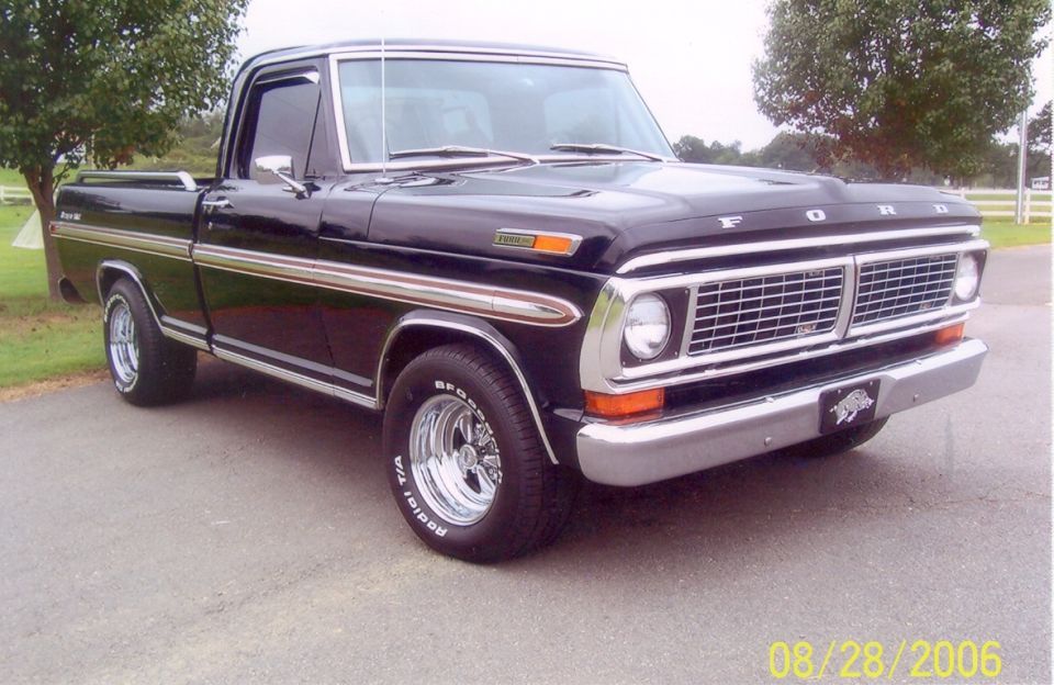 Black Ford pickup truck with chrome trim and wheels. Has a "Ford" badge on the hood and a hog emblem on the front bumper