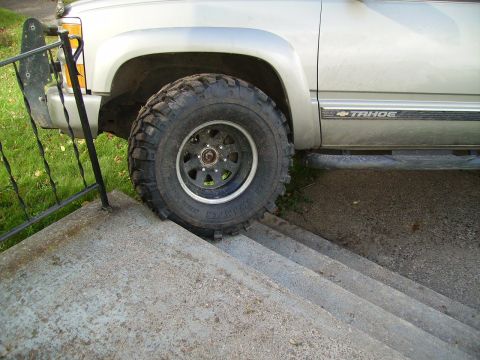 2000 Chevrolet Tahoe - A silver 2000 Chevrolet Tahoe is shown with large off-road tires, partially on a set of stairs.