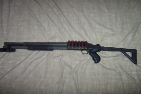 1998 Ford Crown Victoria - A shotgun is shown with ammunition loaded in a side saddle, a pistol grip and tactical stock.