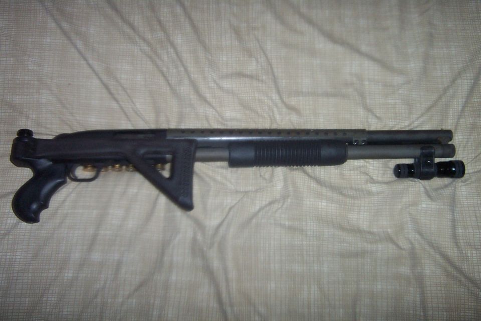 Tactical shotgun with pistol grip, adjustable stock, and mounted flashlight