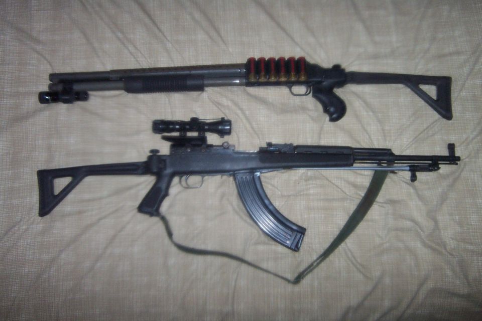 Two firearms, a shotgun with a tactical light and a rifle with a scope and extended magazine