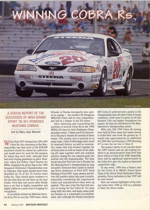 1995 Ford Mustang - A 1995 Ford Mustang Cobra R race car competes on a track, adorned with sponsor decals and the number 20.