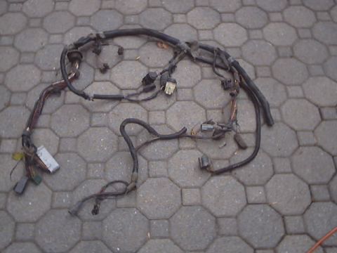 1991 Ford Bronco - A complex automotive wiring harness is displayed on a patterned paver surface.