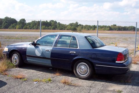 1991 Ford LTD Crown Victoria - A 1991 Ford Crown Victoria LTD is seen parked outdoors, a two-tone blue paint scheme and a partial circular logo on the driver's side door.