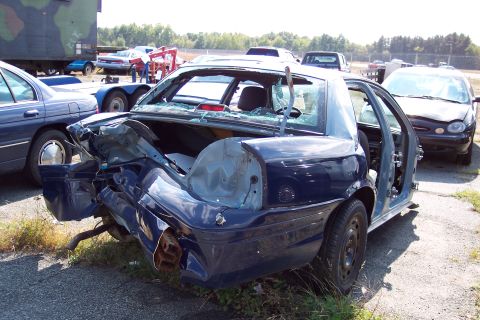 1991 Ford LTD Crown Victoria - This 1991 Ford Crown Victoria LTD shows extensive rear-end damage, including a crushed trunk and broken rear window.