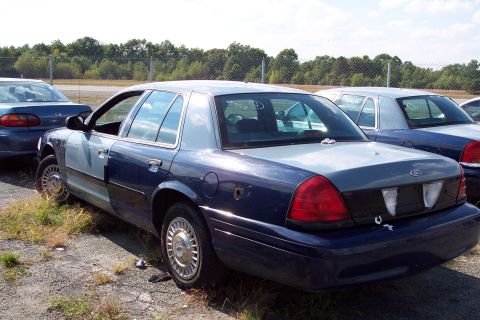 1991 Ford LTD Crown Victoria - A Ford Crown Victoria, likely from the late 1990s, sits in a lot with other vehicles.