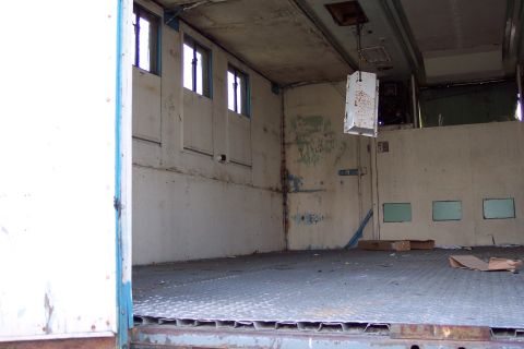 1991 Ford LTD Crown Victoria - The inside of a utilitarian vehicle, possibly a cargo van or truck, appears empty and weathered.