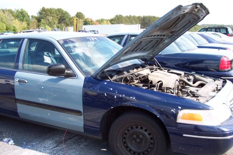 1991 Ford LTD Crown Victoria - This Ford Crown Victoria has a two-tone paint job and its hood is open, revealing the engine compartment.