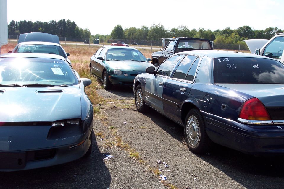 Police car with two-tone paint, bullet holes, and '873' written on rear window