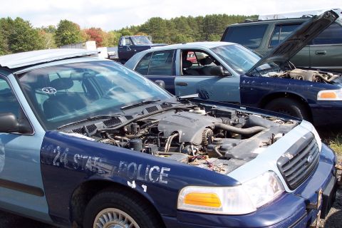 1991 Ford LTD Crown Victoria - A 1991 Ford Crown Victoria LTD police car sits with its hood open, revealing the engine compartment. Other vehicles are visible in the back…
