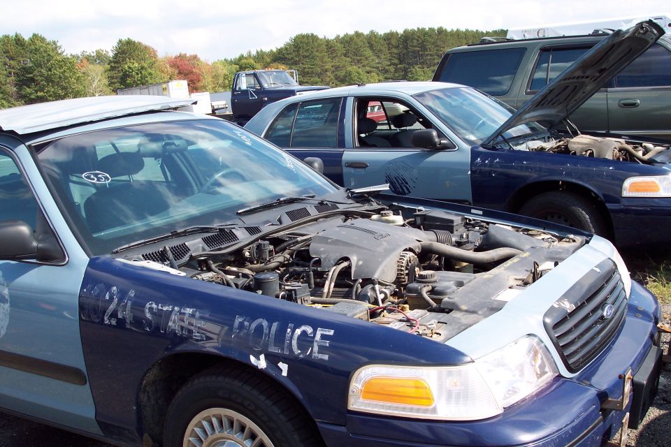 Front view of a 1991 Ford Crown Victoria LTD police car with hood open, showing engine