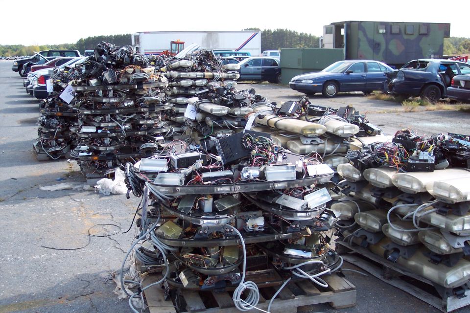 Stacks of police light bars with wiring and electronics