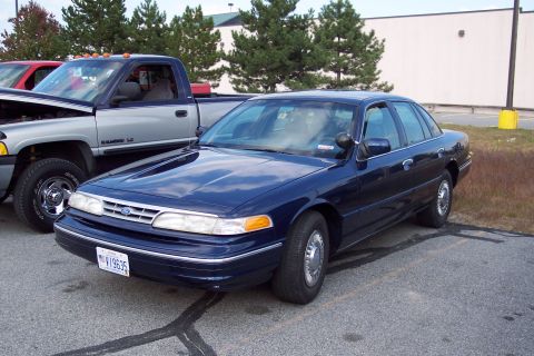 1991 Ford LTD Crown Victoria - Dark blue 1991 Ford Crown Victoria LTD sedan parked in a lot next to a pickup truck.
