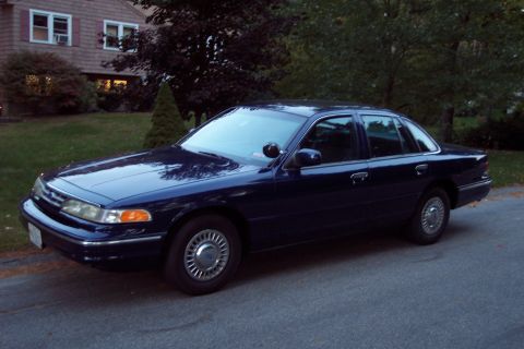 1991 Ford LTD Crown Victoria - A dark blue 1991 Ford Crown Victoria LTD sedan is parked on a residential street.