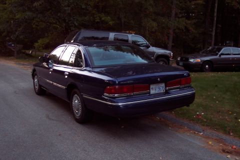 1991 Ford LTD Crown Victoria - Rear view of a dark blue 1991 Ford Crown Victoria LTD, with other vehicles visible.