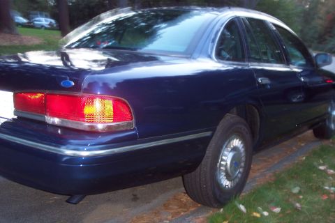 1991 Ford LTD Crown Victoria - Rear view of a dark blue 1991 Ford Crown Victoria LTD, showing its distinctive taillights and chrome accents.