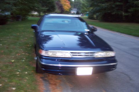 1991 Ford LTD Crown Victoria - Front view of a dark blue 1991 Ford Crown Victoria LTD parked on a residential street.