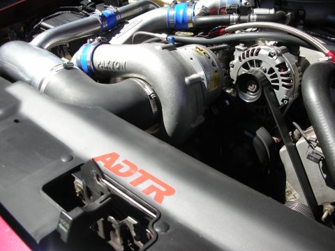 1992 Ford Crown Victoria - Close-up of an engine bay a Paxton supercharger and prominent ADTR branding on the engine cover.