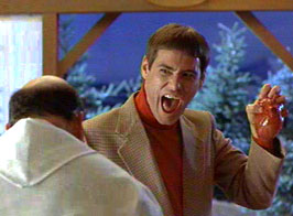 1991 Ford Bronco - A man excitedly presents a fake heart to another person in an indoor setting with Christmas trees visible.
