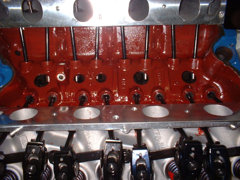 Engine valve train with red painted block and black pushrods