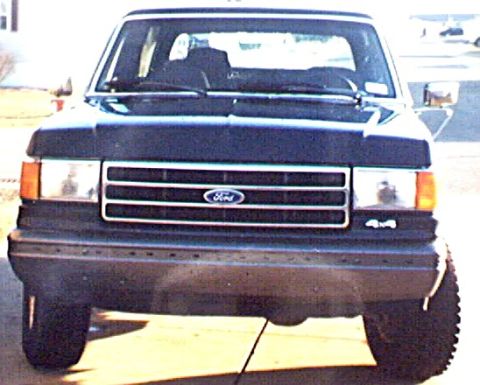 1989 Ford Bronco - This truck features a prominent Ford emblem on its grille and '4x4' badging on the front bumper.