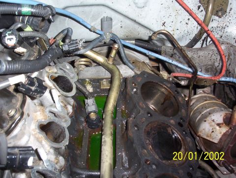 2000 Nissan Xterra - Engine block with cylinder head removed, revealing internal components and coolant.