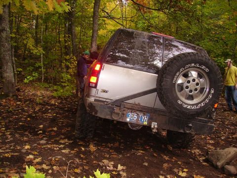 2000 Chevrolet Tahoe - Off-roading in a 2000 Chevrolet Tahoe through a wooded area during autumn.