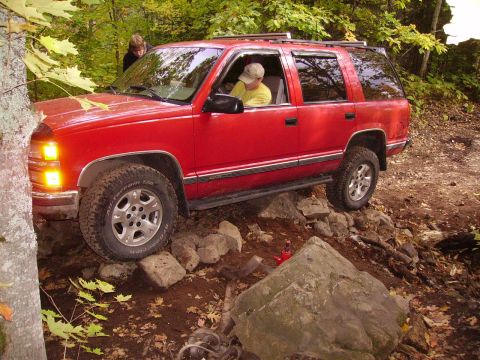 2000 Chevrolet Tahoe - Red 2000 Chevrolet Tahoe navigates a rocky off-road course.