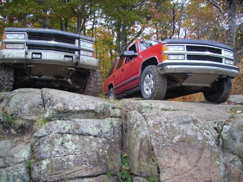 2000 Chevrolet Tahoe - Two SUVs navigate a rocky trail, their off-road capabilities.