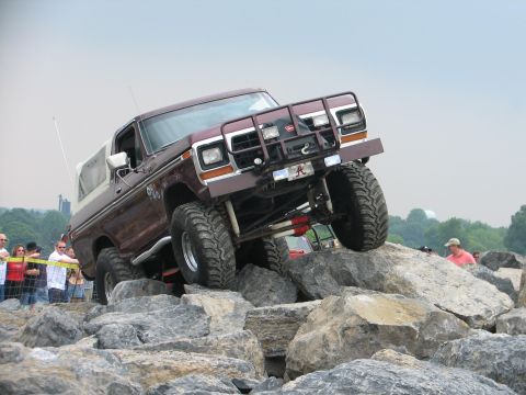 1992 Ford Bronco - This heavily modified 1978 Ford Bronco navigates a challenging rocky terrain, its off-road capabilities.