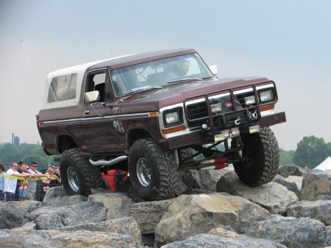1992 Ford Bronco - This modified Ford Bronco navigates a challenging rocky terrain during an off-road event.