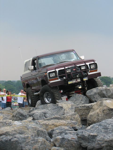 1992 Ford Bronco - This lifted Ford Bronco navigates a challenging rocky obstacle course, its off-road capabilities.