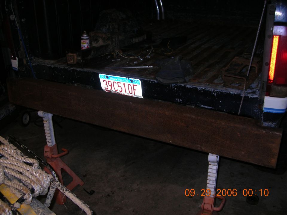 1991 Ford F-150 rear with license plate 39C510F and a wooden plank supported by jack stands