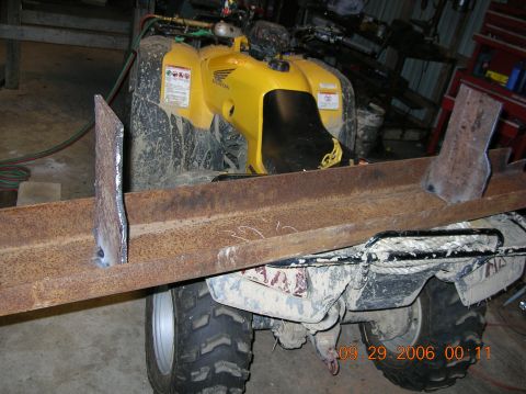 1991 Ford F-150 - A yellow Honda ATV is equipped with a metal beam, possibly for a project.