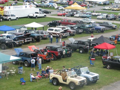 1992 Ford Bronco - Multiple Ford Bronco SUVs and other vehicles are displayed at an outdoor event.