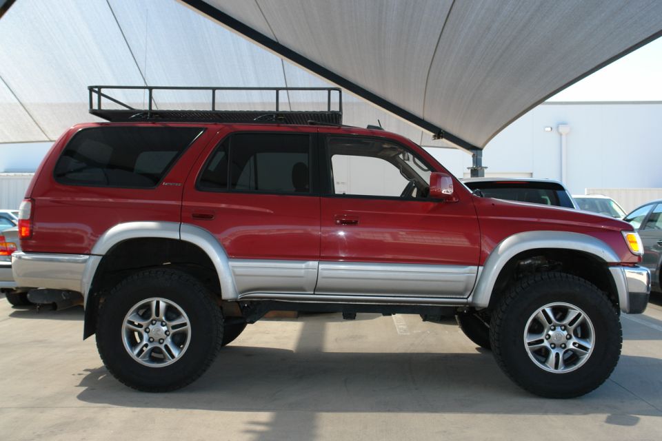 Red 1996 Toyota 4Runner side view with roof rack