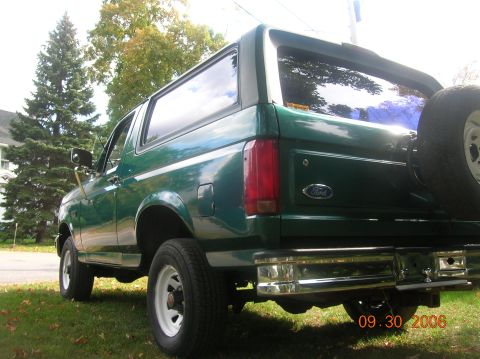 1996 Ford Bronco - This green Ford Bronco is parked on a grassy lawn with trees in the background. A date stamp is visible on the lower right corner of the im…