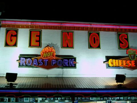 1988 Ford Bronco - The iconic Geno's Steaks sign in Philadelphia features neon lettering for 'Hot Roast Pork' and 'Cheese'.