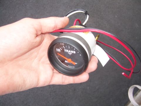 2002 Ford F-250 - A transmission temperature gauge is held in a hand, showing a reading of 100 degrees.