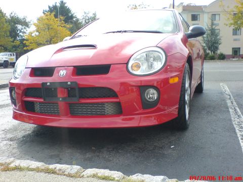 2005 Dodge SRT-4 - Front view of a red 2005 Dodge SRT-4 with a visible intercooler.